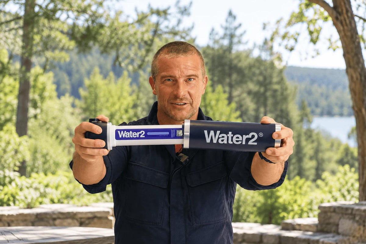 Bear Grylls holding the Water2 filter outdoors